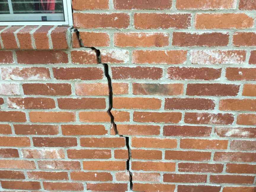 foundation repair cracks in bricks next to window
