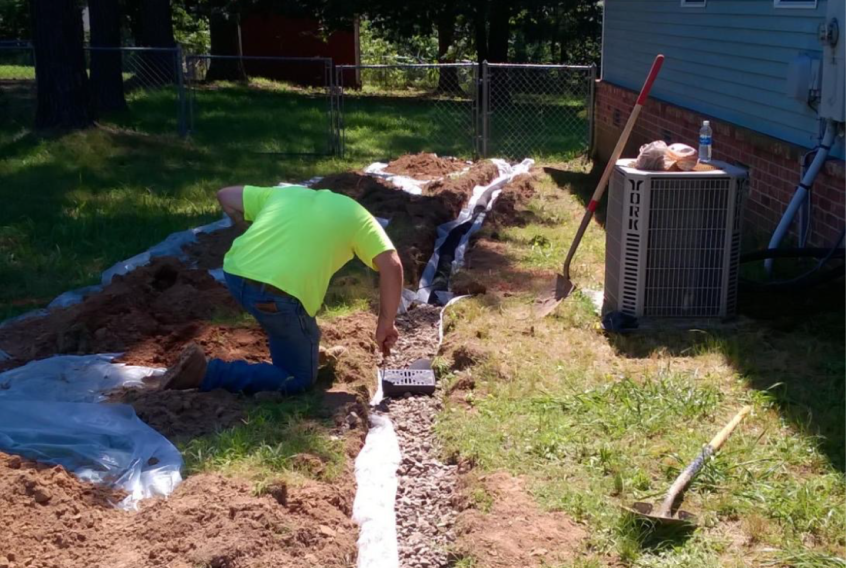 French Drain Installation by technician at a residential property