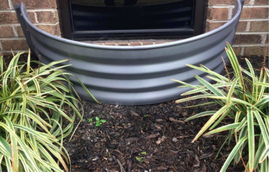 a vent well next to a home